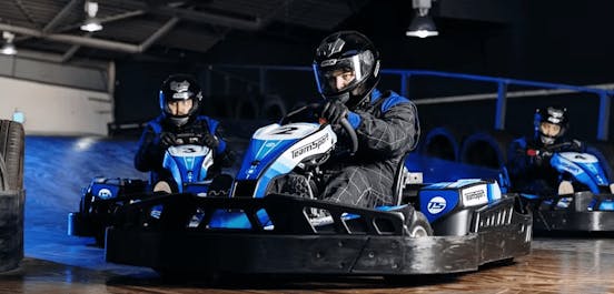 three karters in blue electric karts