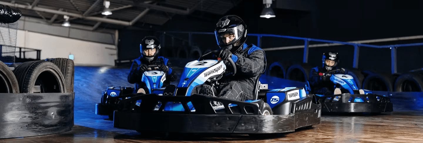 three karters in blue electric karts