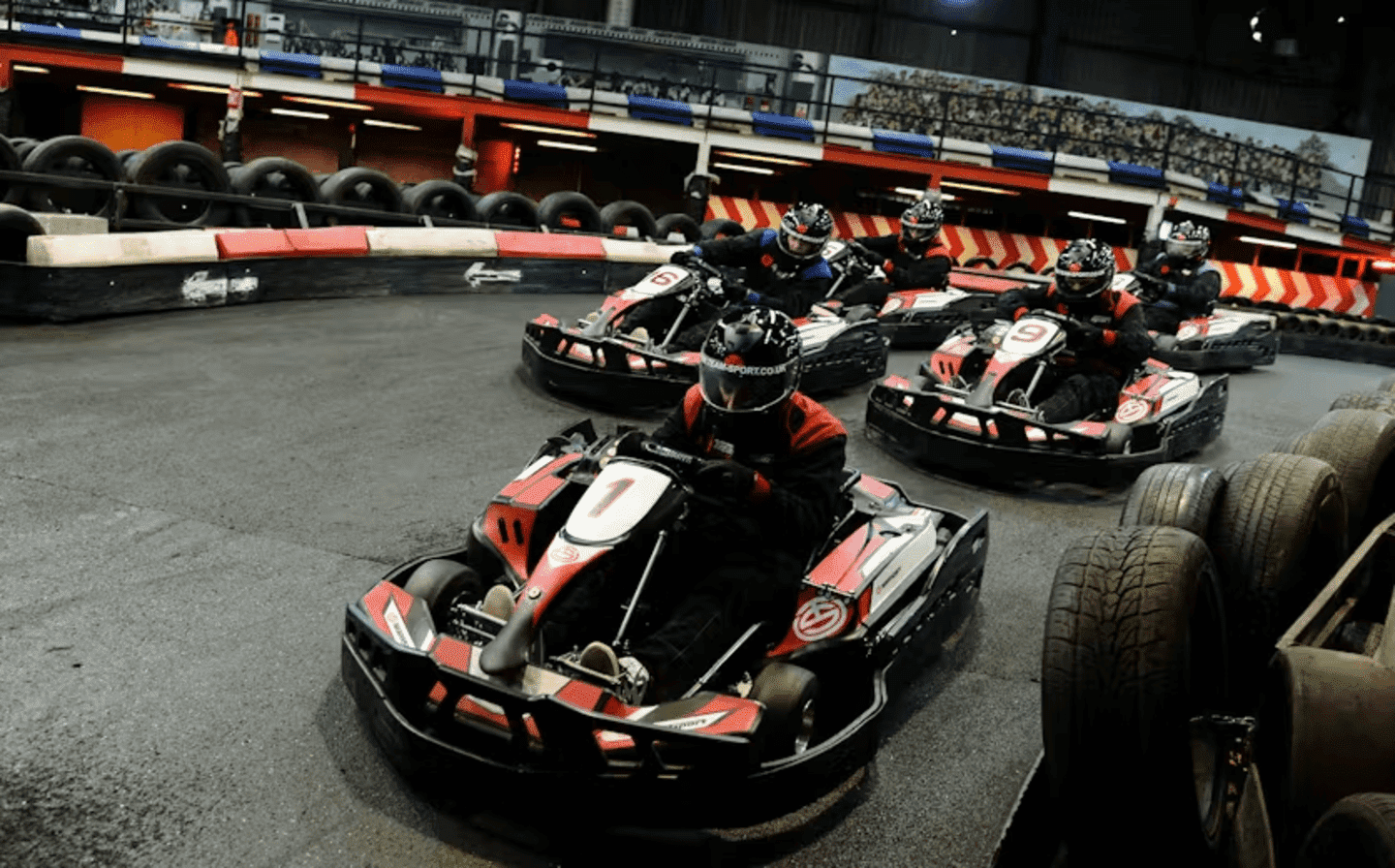 Group of go karters in red petrol karts