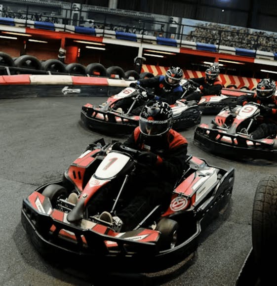 Group of go karters in red petrol karts