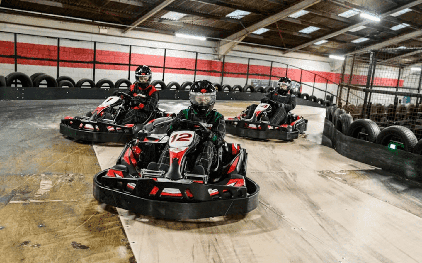 three karters in red petrol karts