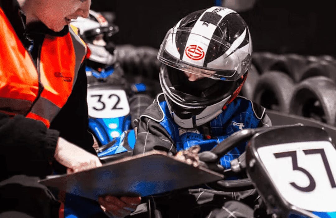 Tutor helping karter at race academy session