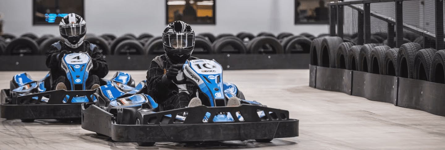 Two go-karters in blue electric karts