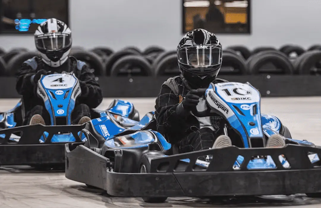 Two go-karters in blue electric karts