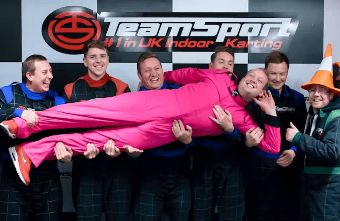 stag-do party group holding the bachelor