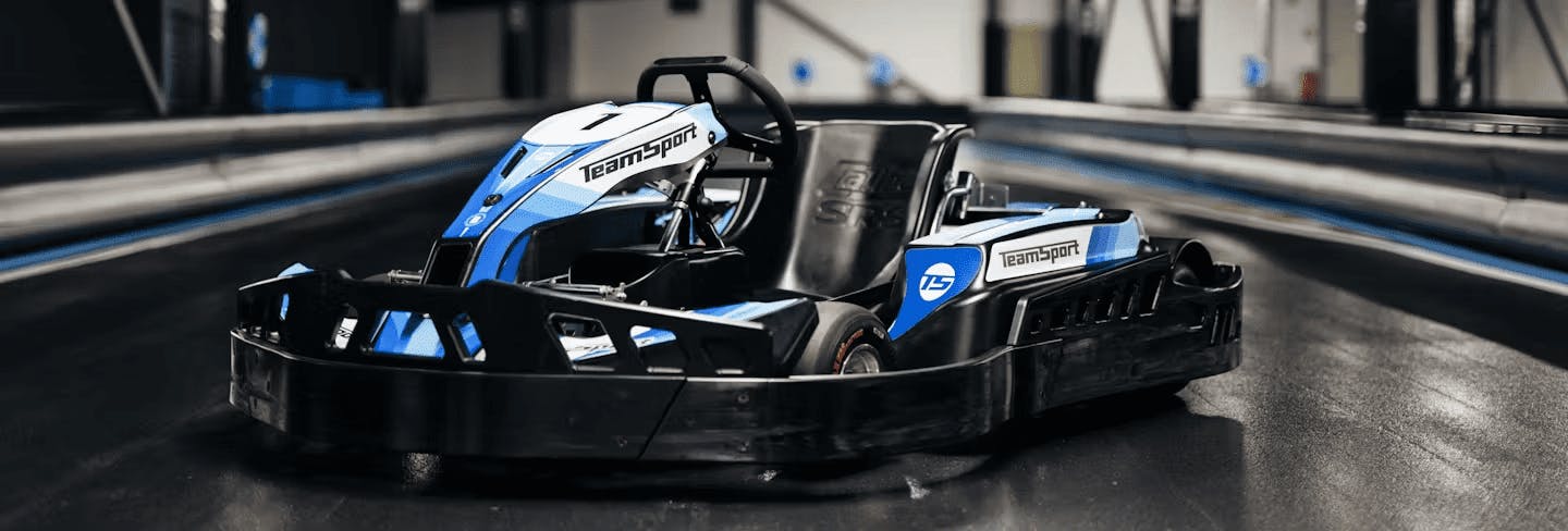 posed blue electric kart in middle of track