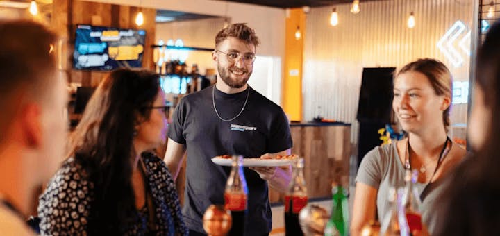 food being delivered to a table at TeamSport venue