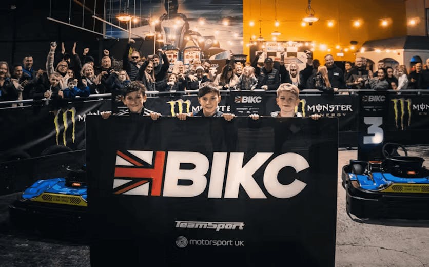 BIKC cadets 2023 holding BIKC sign with crowd cheering behind