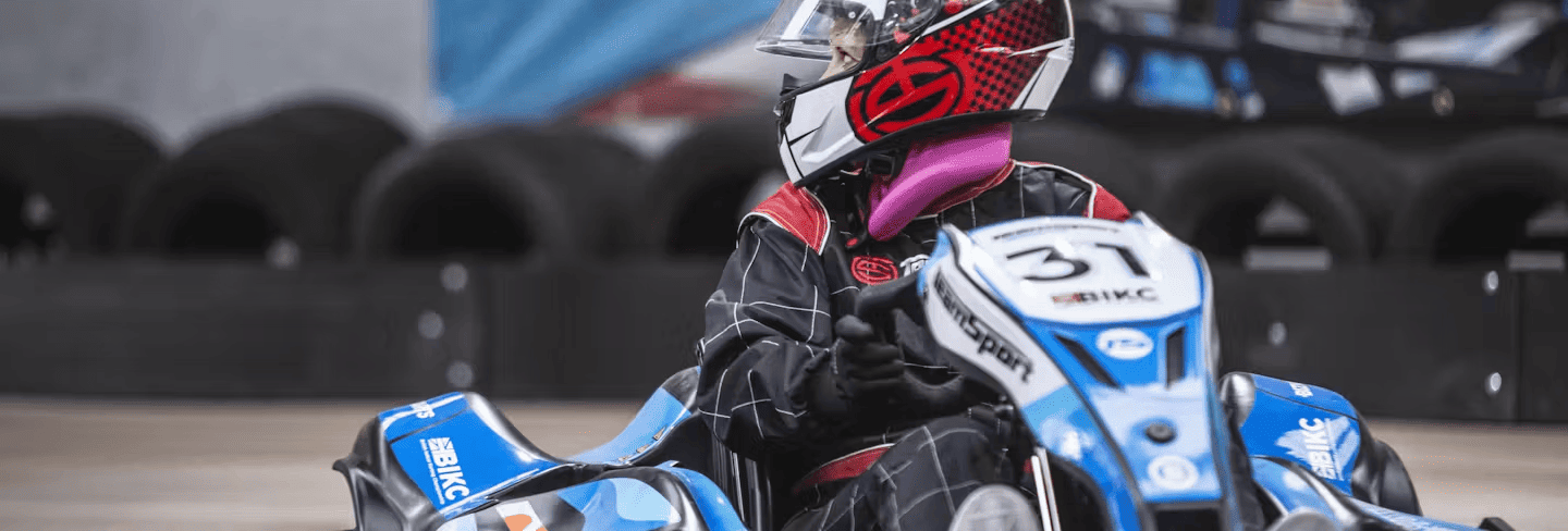 Girl karting in a blue E-kart