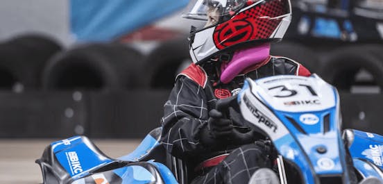 Girl karting in a blue E-kart