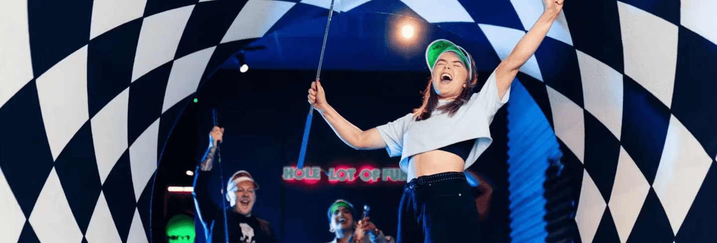 Girl cheering as she plays Putt Club