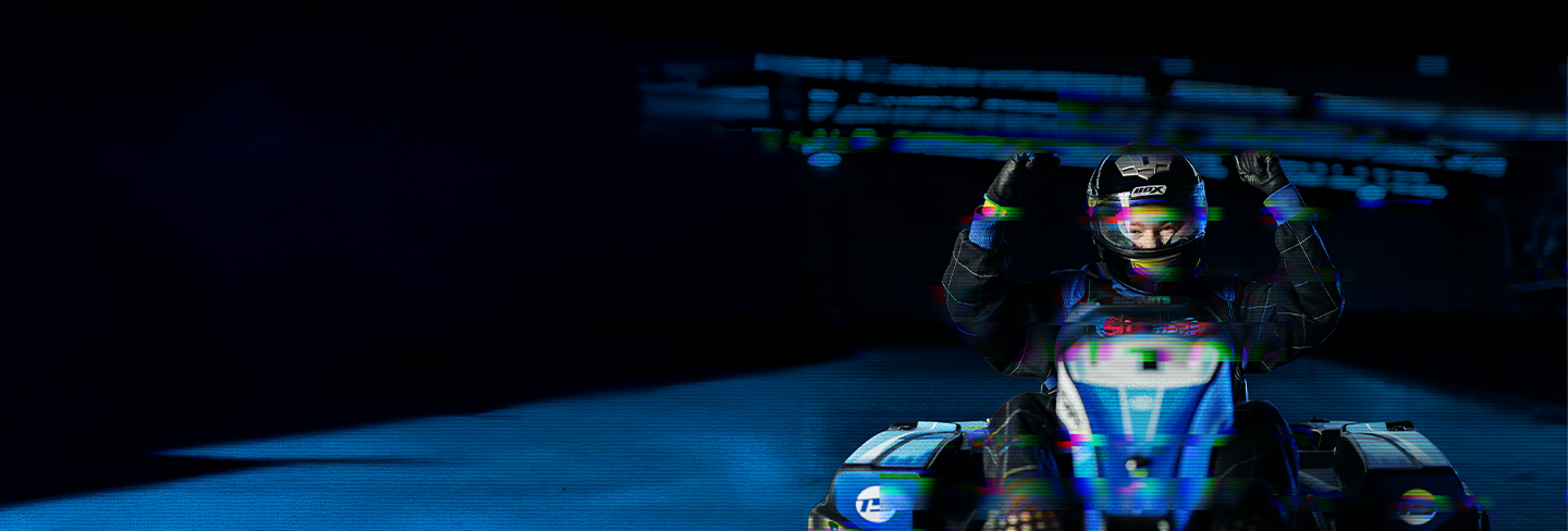 Arms in the air, sitting in a go kart