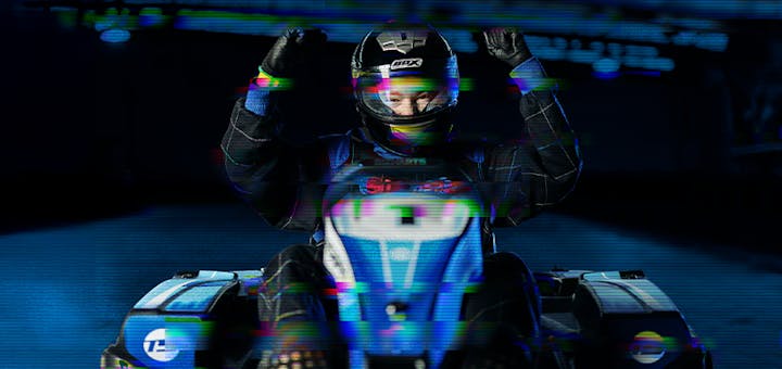Arms in the air, sitting in a go kart
