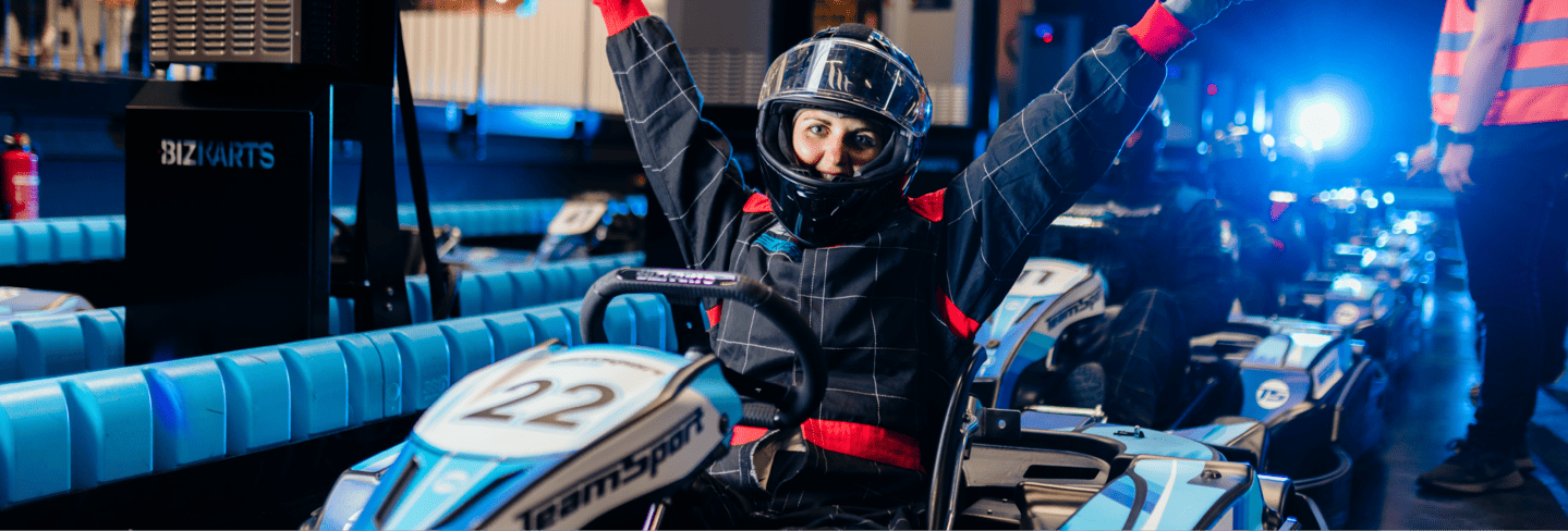 Boxing Day 2025 banner with a woman in a go kart with her arms in the air