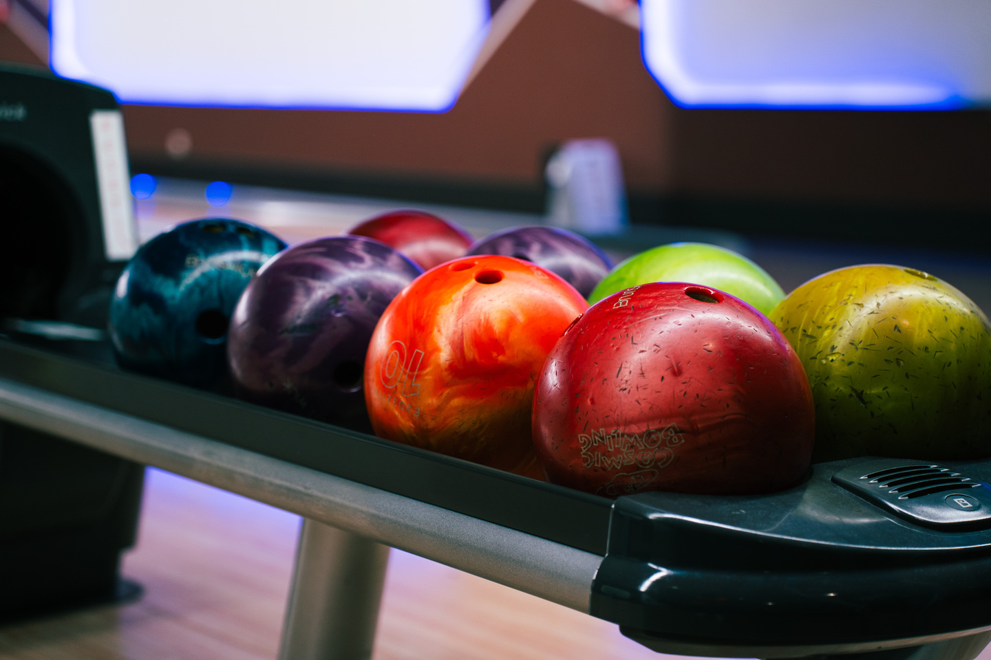 Close up of bowling balls lined up on ball return