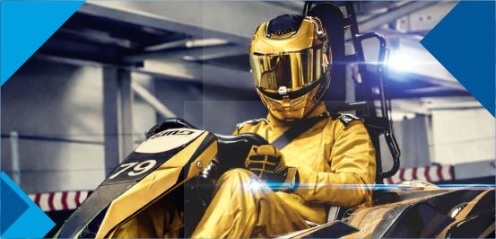 Ein Rennfahrer in einem goldenen Rennanzug mit Helm sitzt im Go Kart 