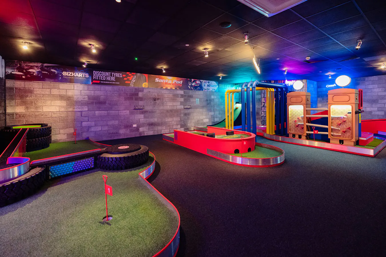 Putt Club Edmonton motorsport‑themed crazy golf hole with track‑inspired obstacles