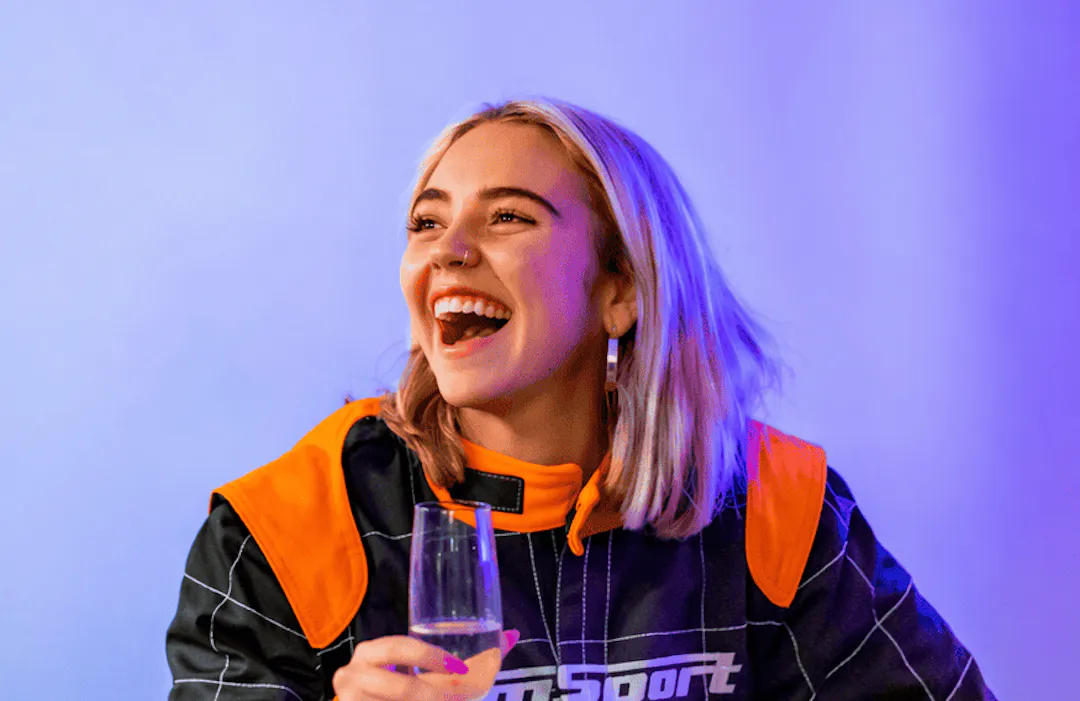 Corporate party enjoying a drink dressed in a race suit