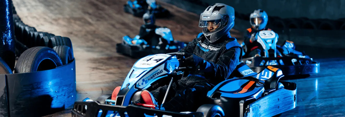 Group of go karters in blue electric karts
