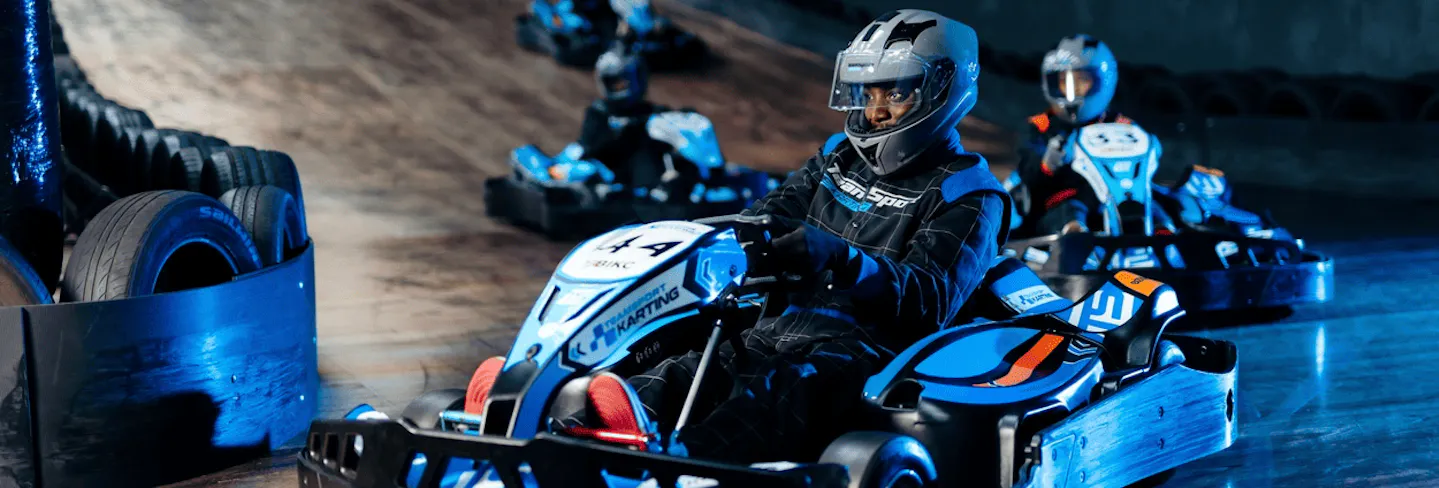Group of go karters in blue electric karts