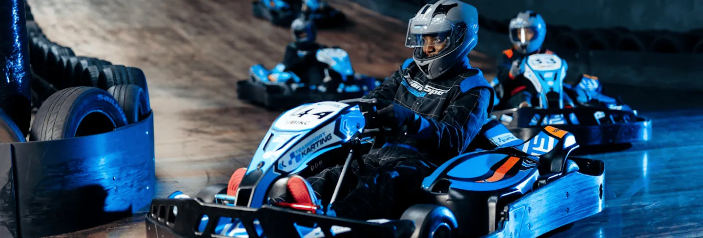 Group of go karters in blue electric karts