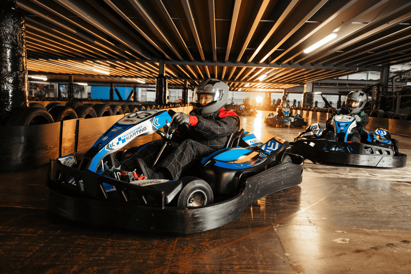 Group of go karters in blue electric karts