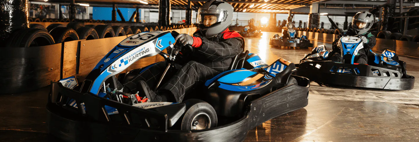 Group of go karters in blue electric karts