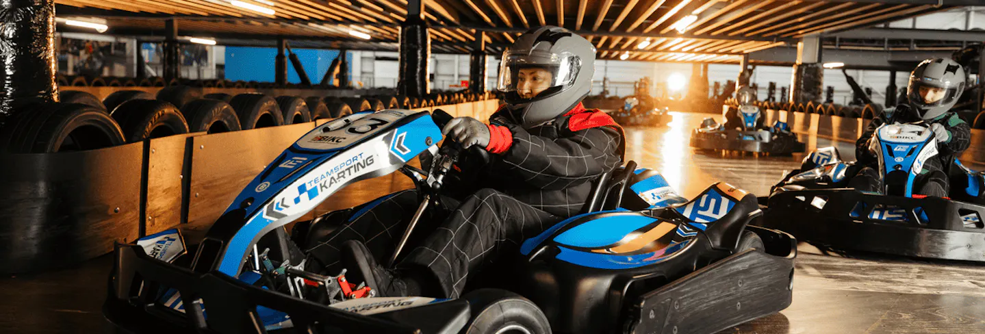 Group of go karters in blue electric karts
