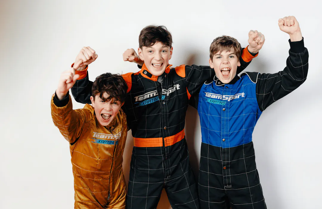 Three kids cheering at a birthday party