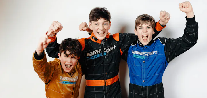 Three kids cheering at a birthday party