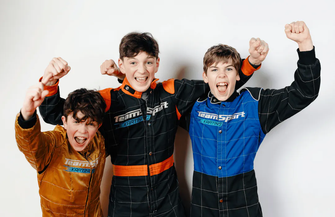 Three kids cheering at a birthday party