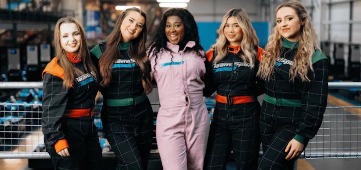 Group of girls posing by go karting track