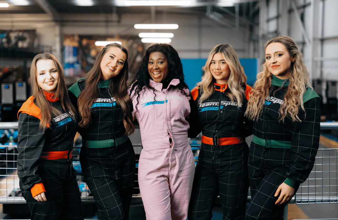 Group of girls posing by go karting track