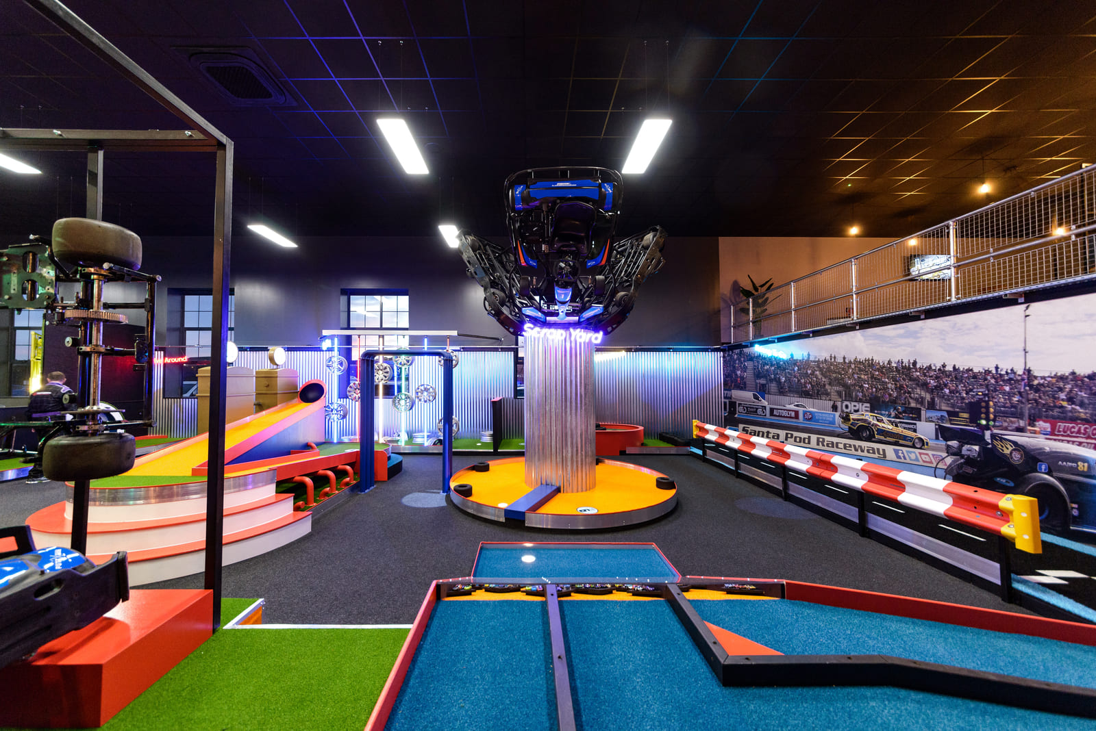 Motorsport‑themed crazy golf venue interior
