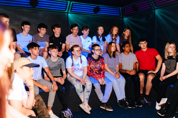 Group receiving a laser tag briefing indoors