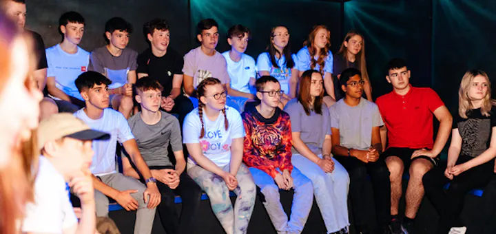 Group receiving a laser tag briefing indoors