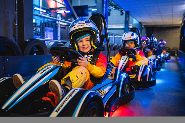 Child enjoying their first go karting experience in a mini racer