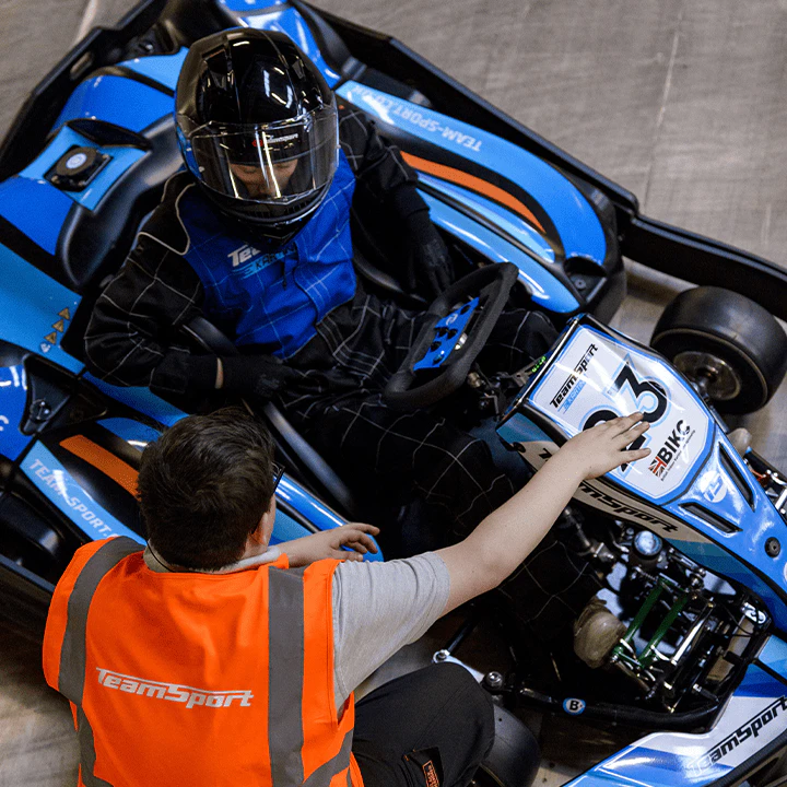 Go-kart driver racing around a corner