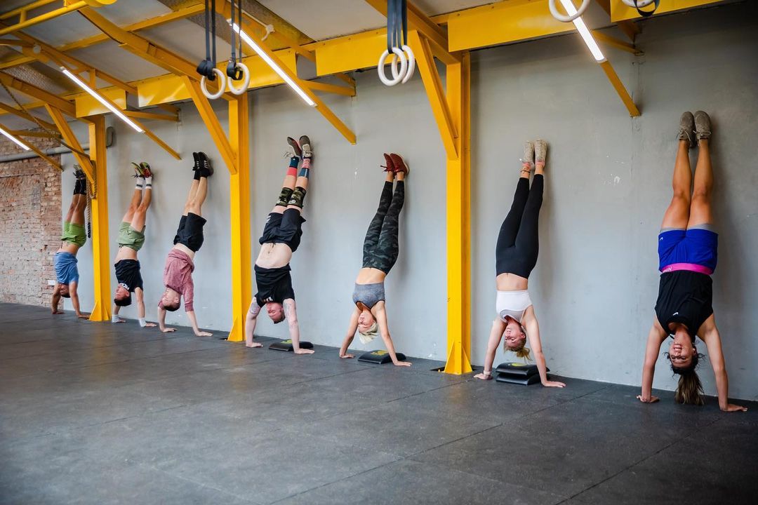 Members of CrossFit Tay Ho doing handstands