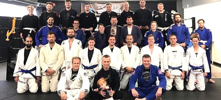 Martial arts students and their teachers pose for a team photo.