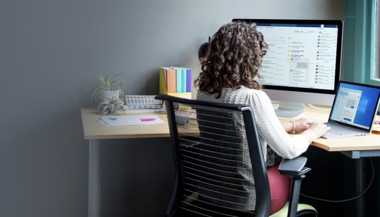 Woman sitting at a computer working with Microsoft Dynamics