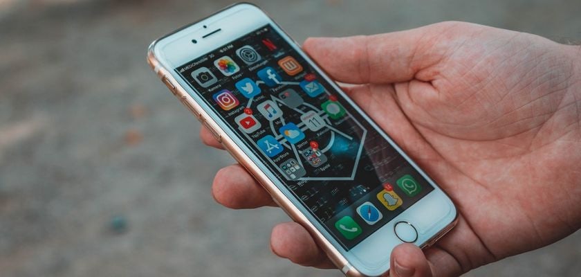 Hand holding an iPhone.