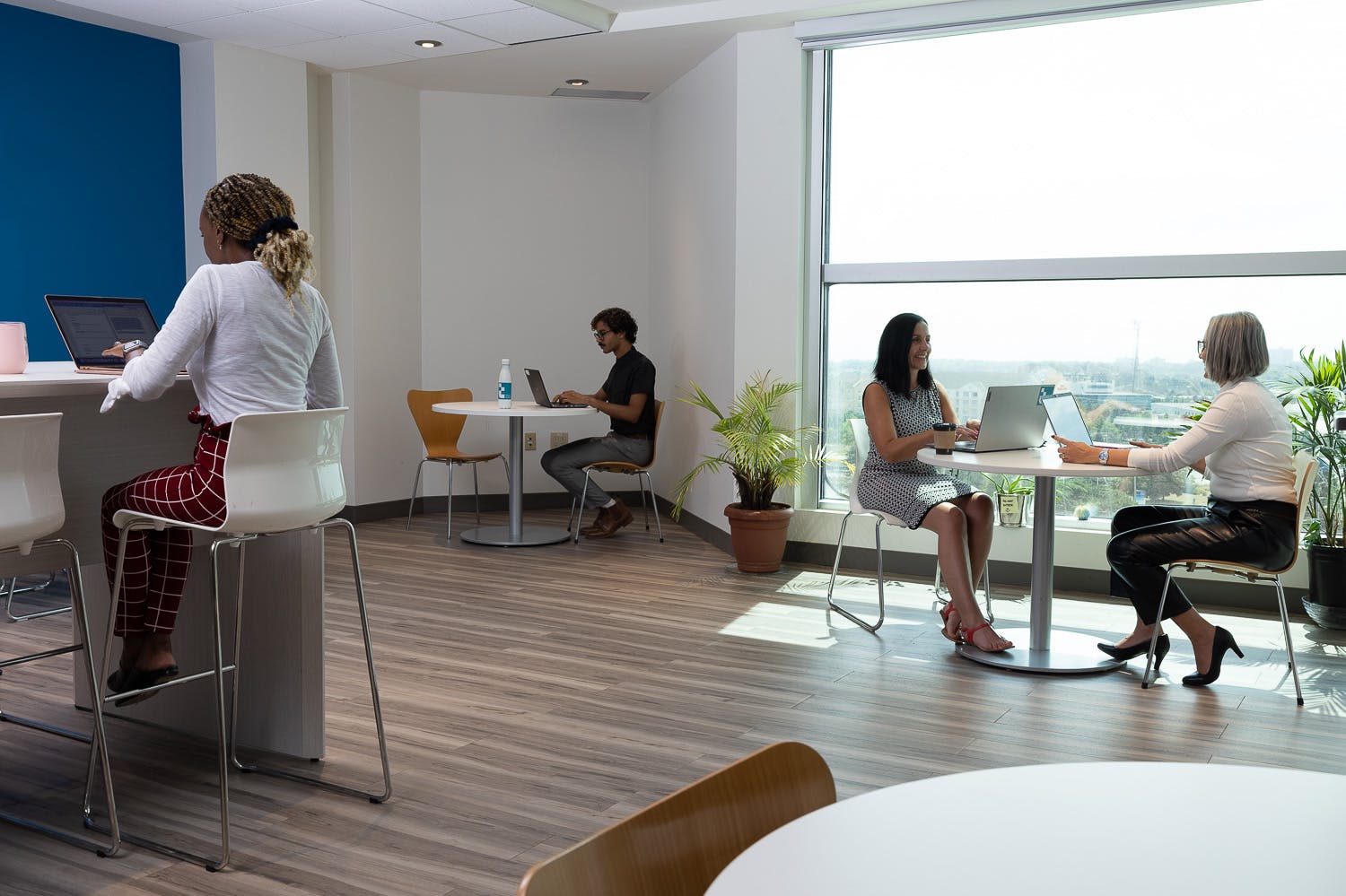Techplace members eating at tables in the kitchen