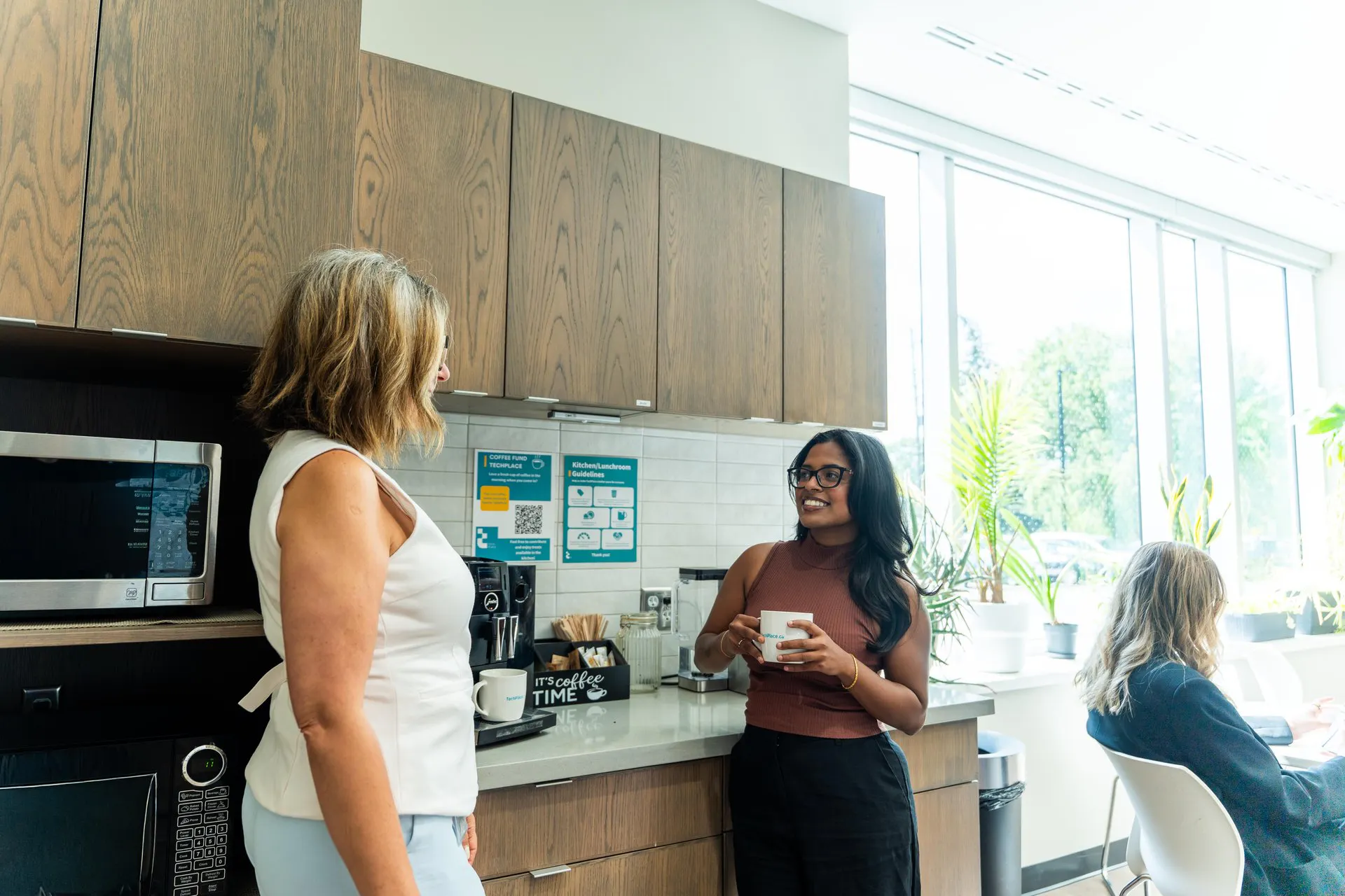 Two women chatting in kitchen at TechPlace