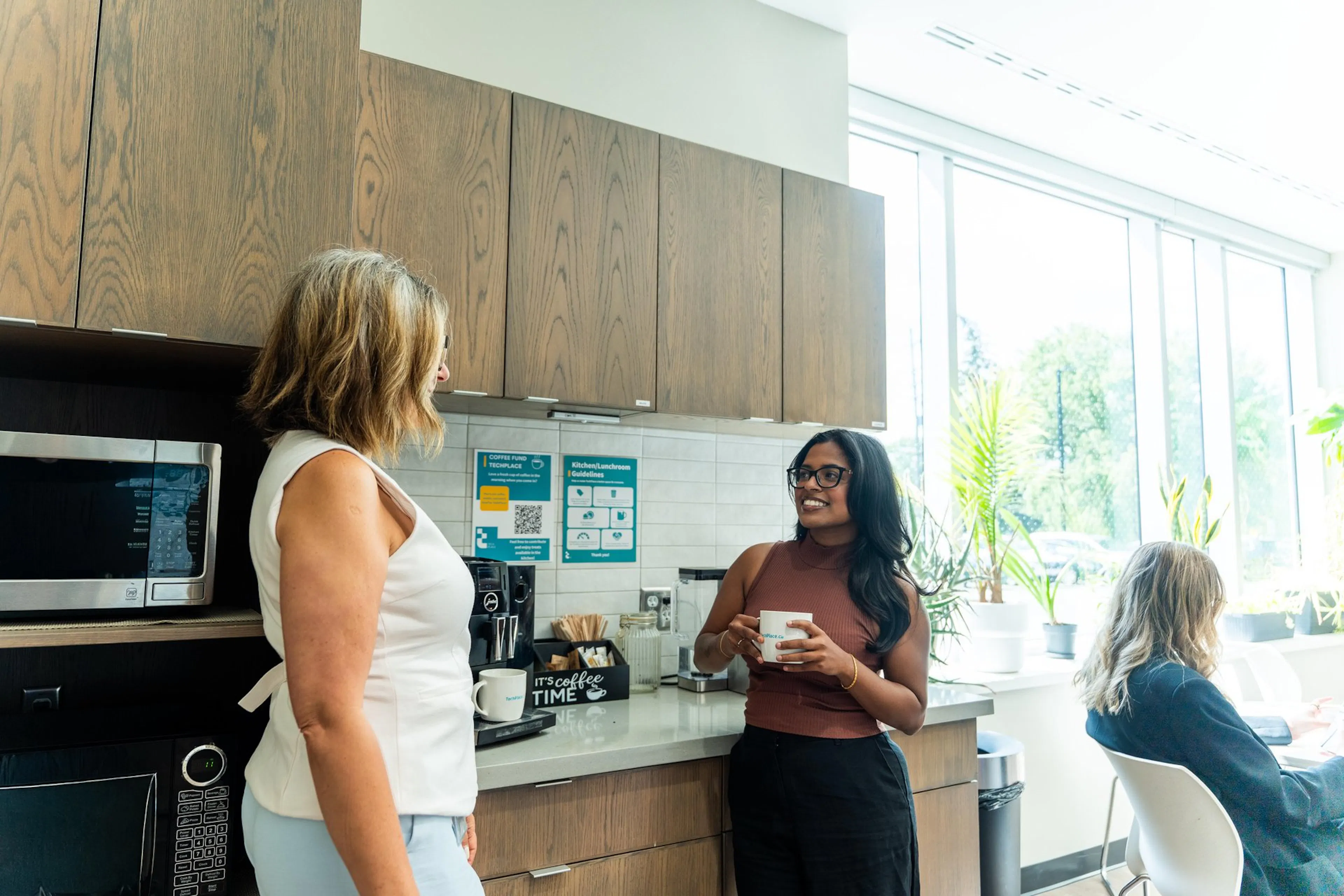 Two women chatting in kitchen at TechPlace