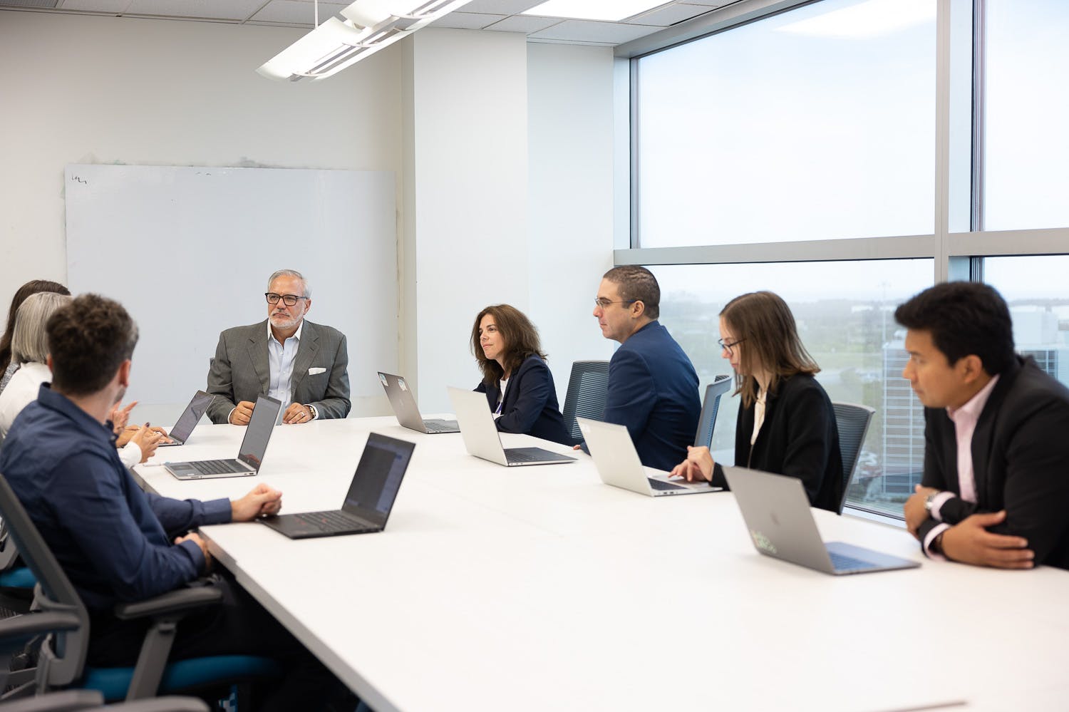 Team members meet in the boardroom