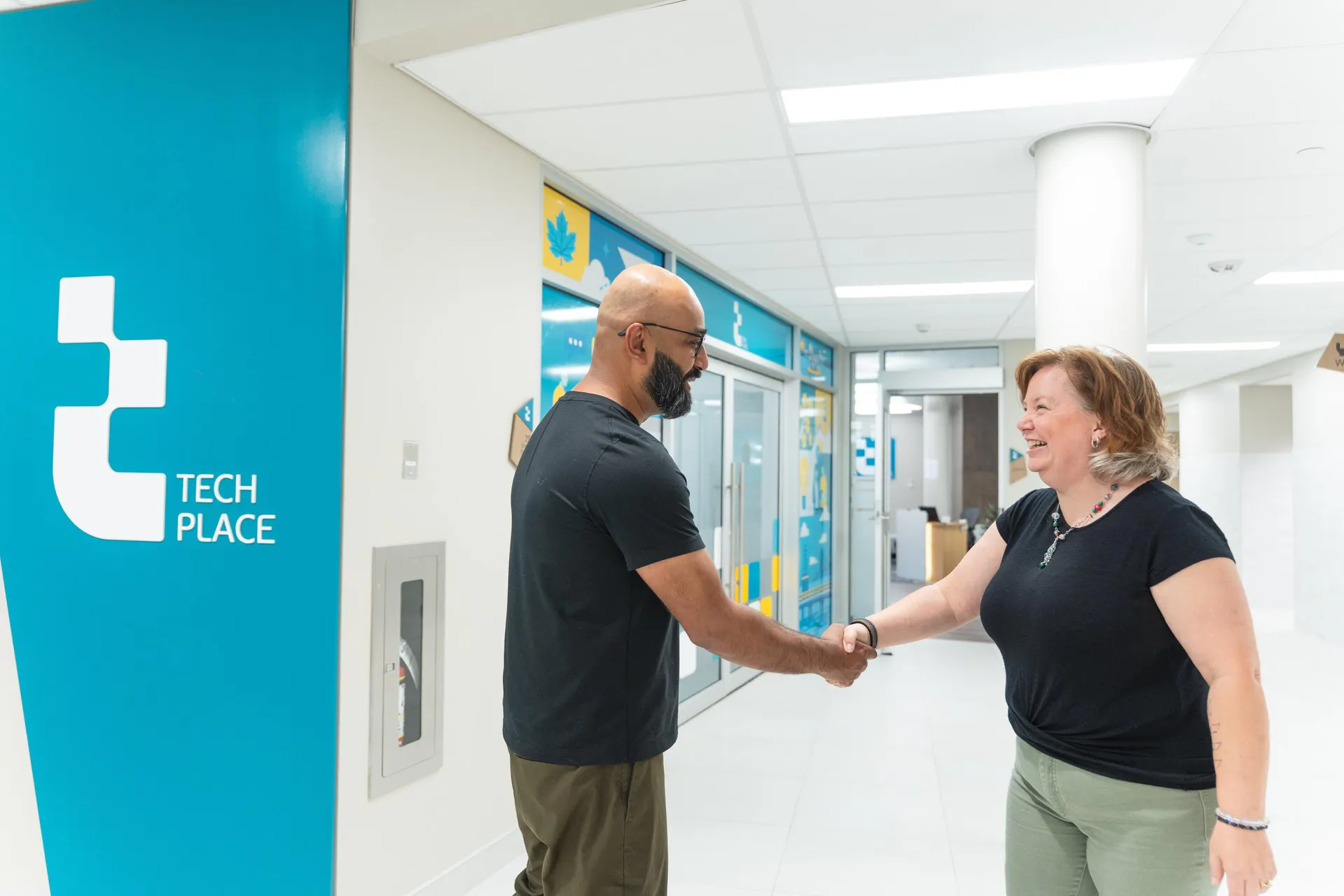 Two people shaking hands in front of TechPlace