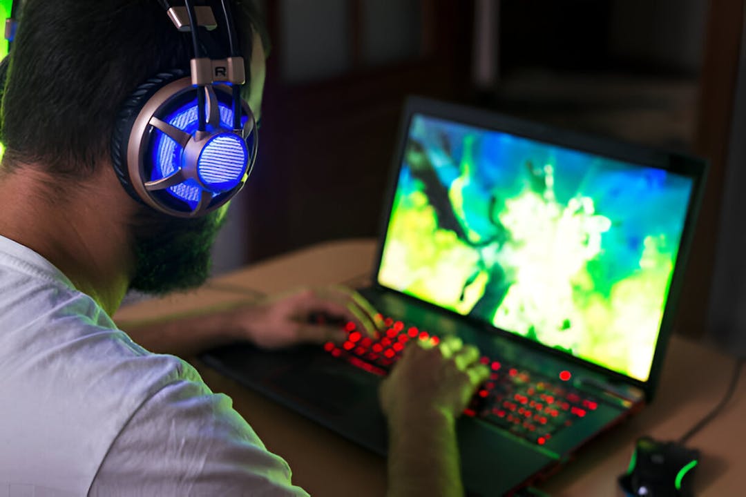 Young gamer playing video game wearing headphone. stock photo