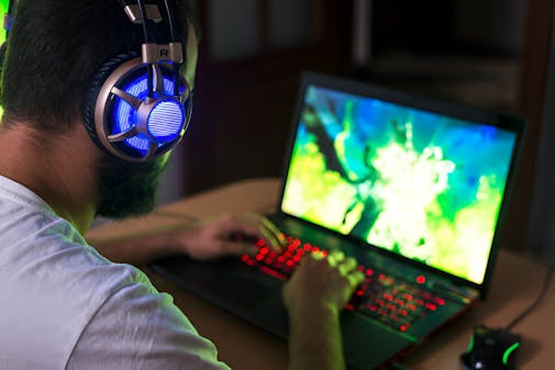 Young gamer playing video game wearing headphone. stock photo