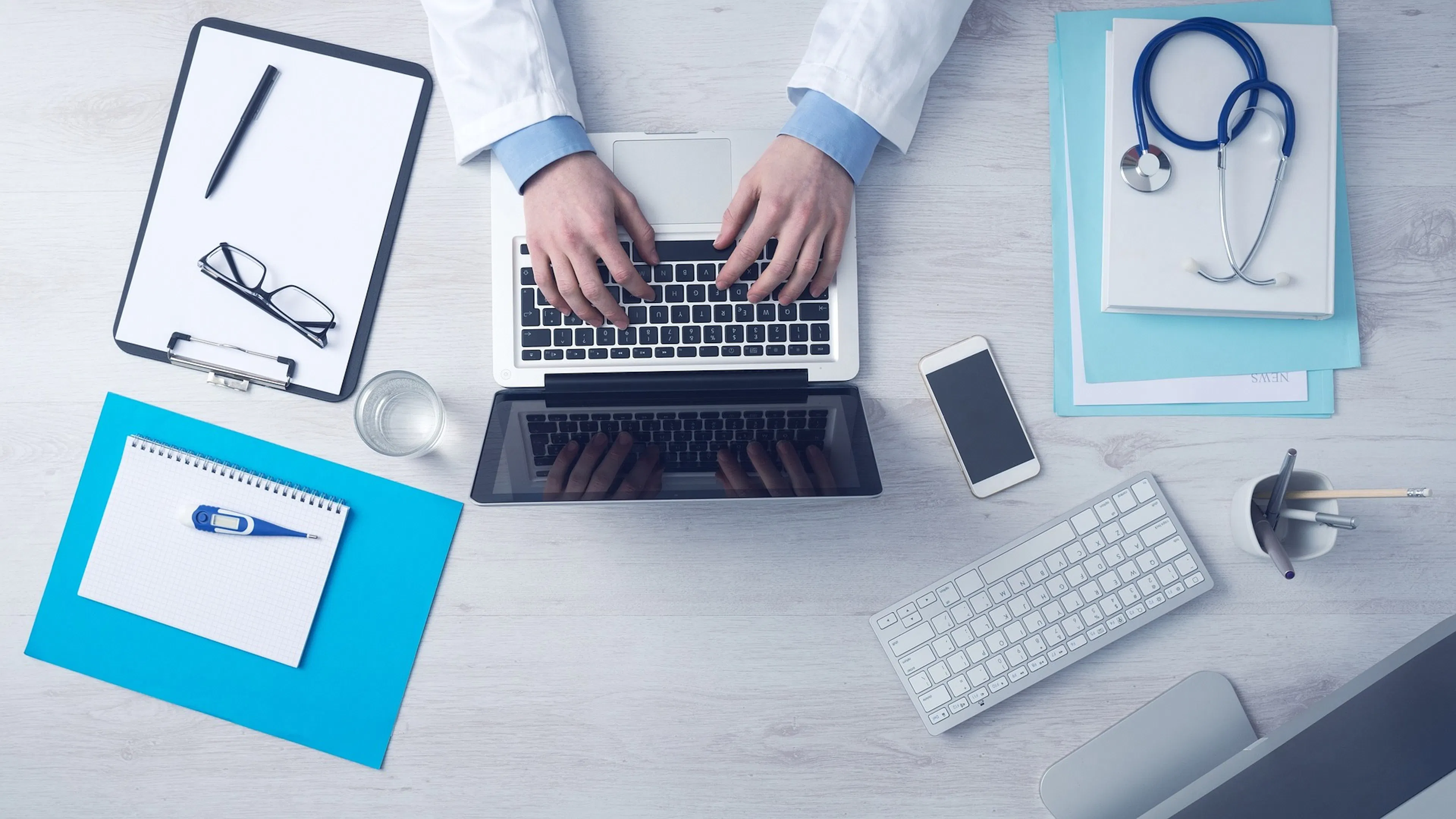A clinician reviewing health data on a laptop — choosing the right tech stack starts with understanding HIPAA requirements